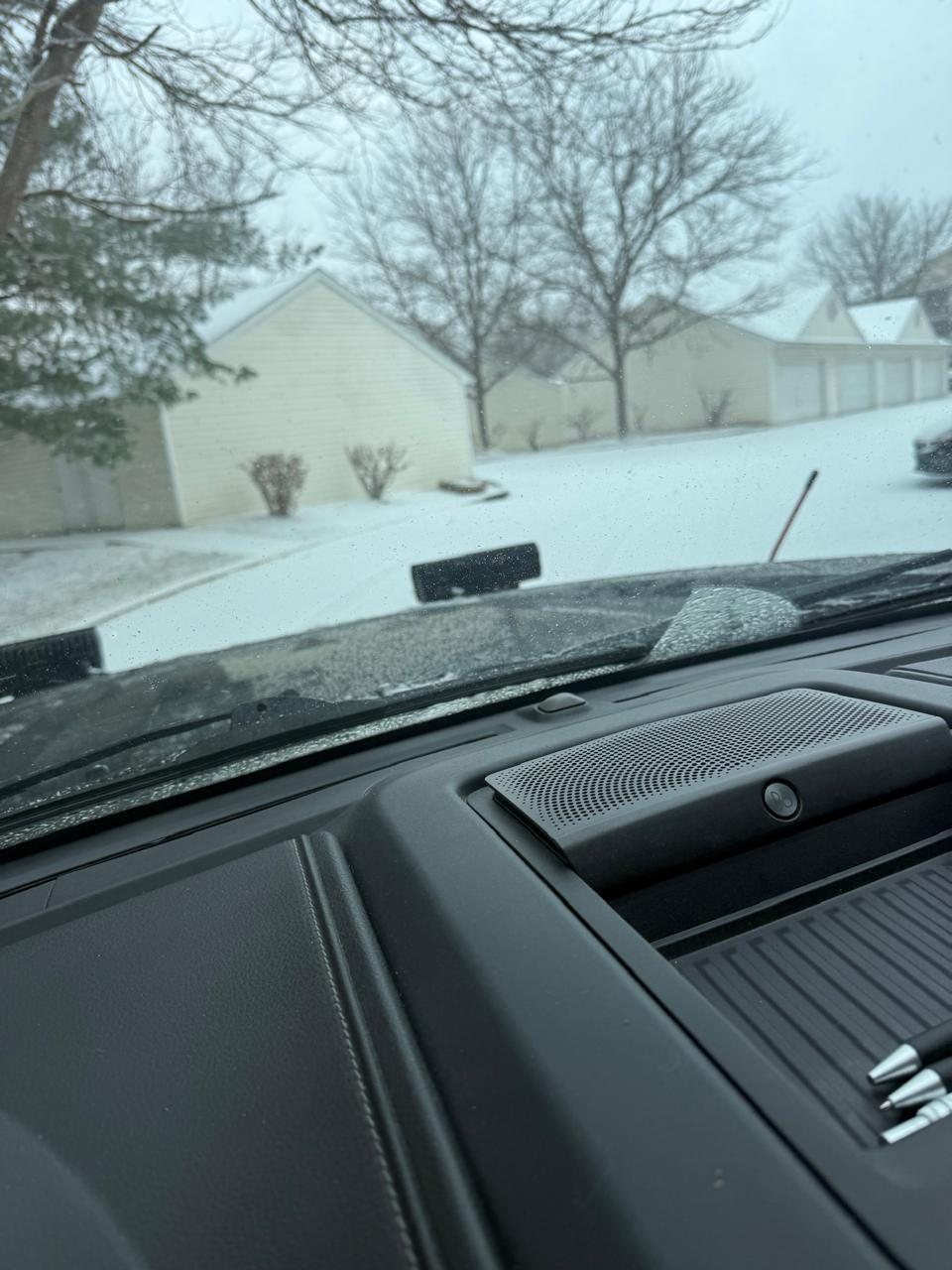 Plow truck clearing the drive in front of a row of garages